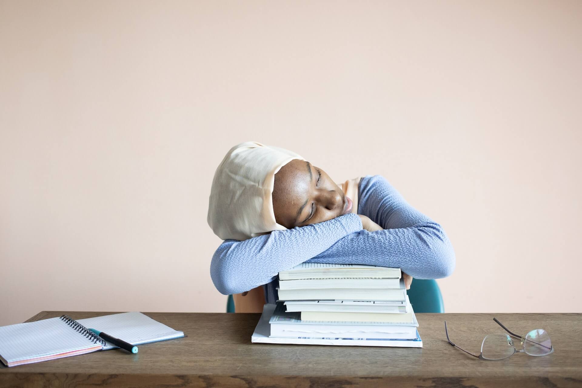 tired student sleeping on books