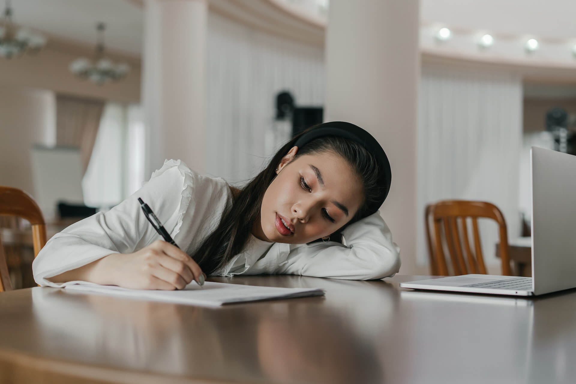 woman writing in her notebook
