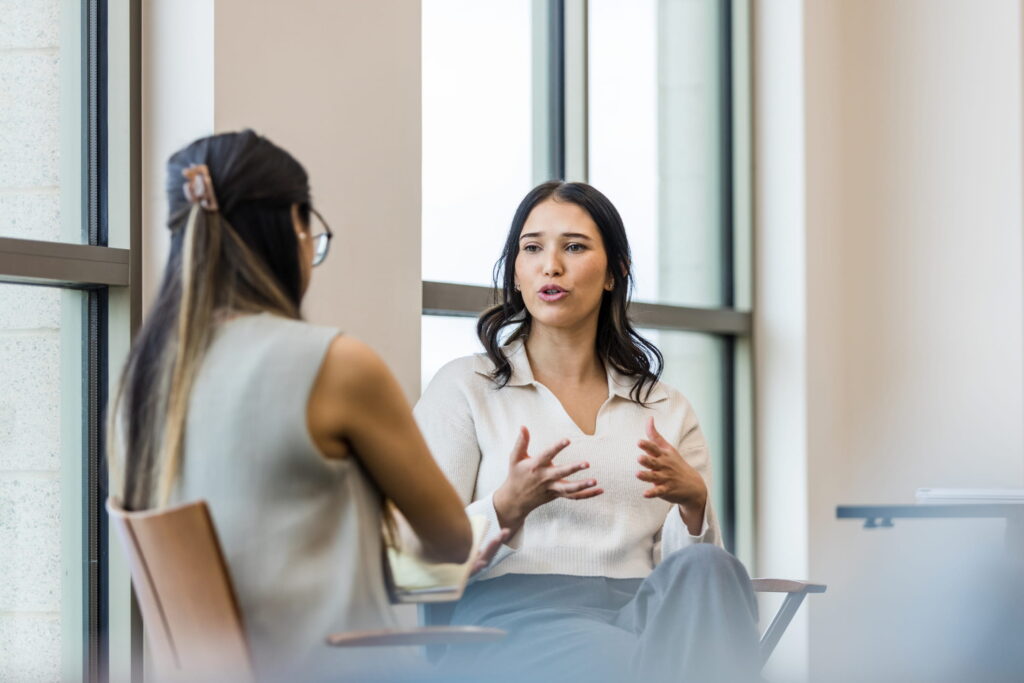 two women speaking english fluently in an office